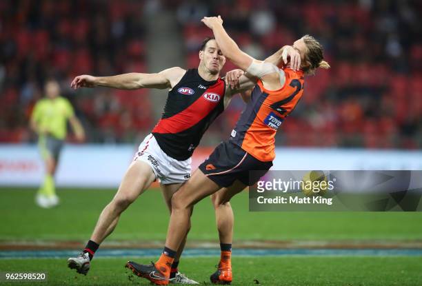 Matt Dea of the Bombers competes for the ball against Harrison Himmelberg of the Giants during the round 10 AFL match between the Greater Western...