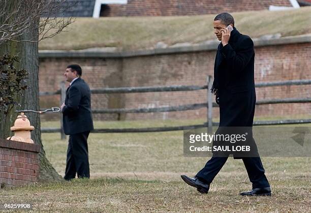 President Barack Obama talks on a cellphone after arriving on Marine One at Fort McHenry in Baltimore, Maryland, January 29, 2010. Obama is traveling...