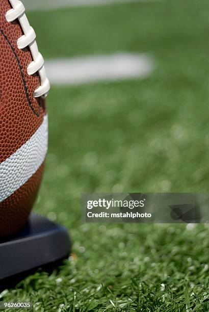 football sitting on tee - american football ball stadium stock pictures, royalty-free photos & images