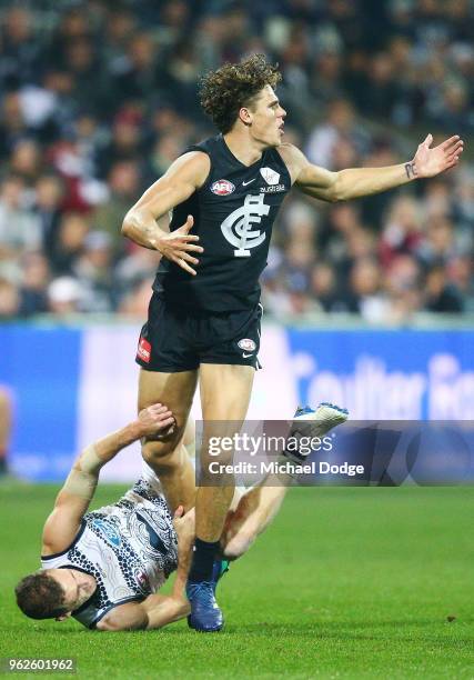 Charlie Curnow of the Blues stomps over Joel Selwood of the Cats off the ball during the round 10 AFL match between the Geelong Cats and the Carlton...