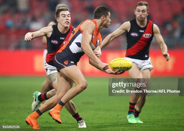 Josh Kelly of the Giants handpasses during the round 10 AFL match between the Greater Western Sydney Giants and the Essendon Bombers at Spotless...