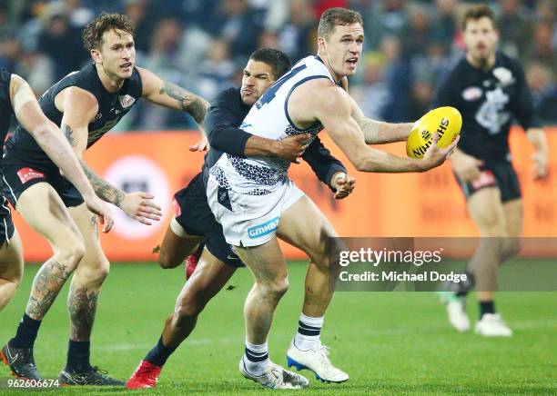 Sam Petrevski-Seton of the Blues tackles Joel Selwood of the Cats during the round 10 AFL match between the Geelong Cats and the Carlton Blues at...