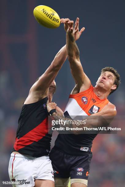 Tom Bellchambers of the Bombers contests the ball with Rory Lobb of the Giants during the round 10 AFL match between the Greater Western Sydney...