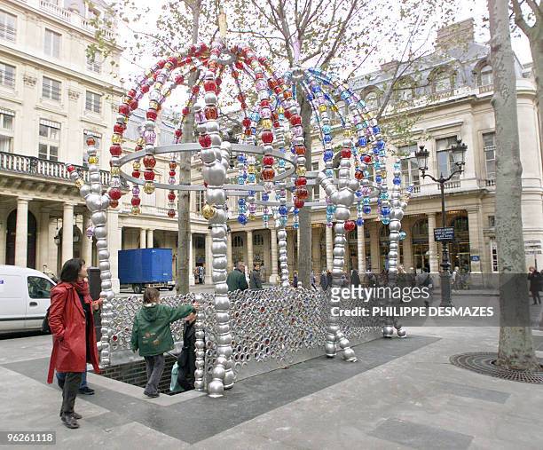 Woman looks at the Palais Royal underground station's new decoration in central Paris 31 October 2000, made by glass and aluminium balls set up by...