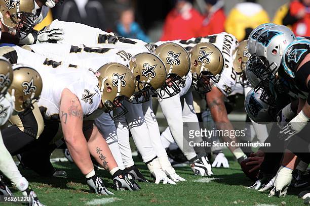 Members of the New Orleans Saints line up for a play at the line of scrimmage against the Carolina Panthers at Bank of America Stadium on January 3,...