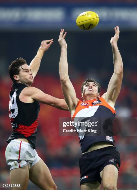 Jeremy Cameron of the Giants takes a mark under pressure from Matt Dea of the Bombers during the round 10 AFL match between the Greater Western...