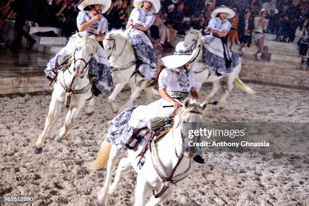 Horsewomen give a demonstration on the runway during Christian Dior Couture S/S19 Cruise Collection show on May 25, 2018 in Chantilly, France.