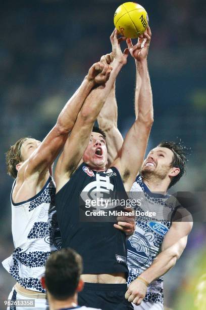 Patrick Dangerfield of the Cats and Matthew Kreuzer of the Blues compete for the ball during the round 10 AFL match between the Geelong Cats and the...