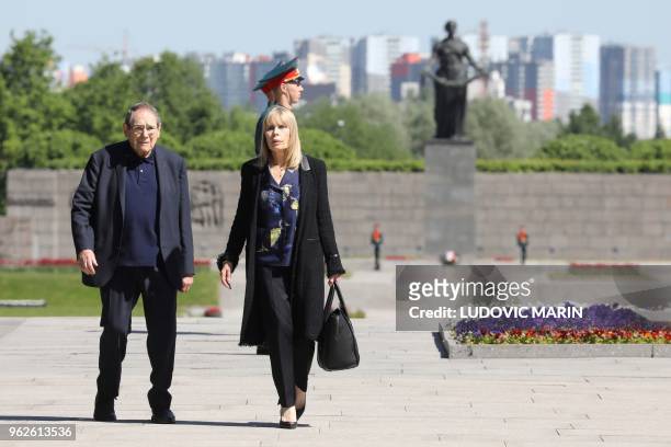French director Robert Hossein and his wife Candice Patou take part in a ceremony at the Piskaryovskoye Memorial Cemetery, where the victims of the...