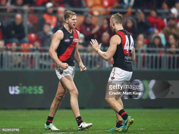 James Stewart of the Bombers celebrates with Shaun McKernan of the Bombers after kicking a goal during the round 10 AFL match between the Greater...