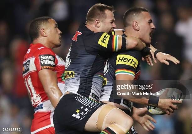 Reagan Campbell-Gillard of the Panthers celebrates scoring a try with team mate Trent Merrin of the Panthers during the round 12 NRL match between...