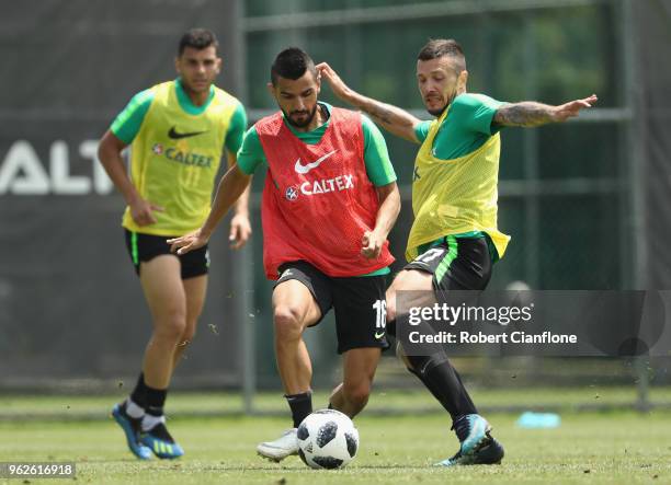 Aziz Behich of Australia is challenged by Nikita Rukavytsya during the Australian Socceroos Training Session at the Gloria Football Club on May 26,...