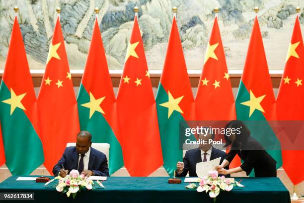 China's Foreign Minister Wang Yi and Burkina Faso Foreign Minister Alpha Barry attend a signing ceremony establishing diplomatic relations between...