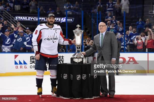 Alex Ovechkin of the Washington Capitals and NHL Deputy Commissioner Bill Daly pose with the Prince of Wales Trophy after the Capitals defeated the...