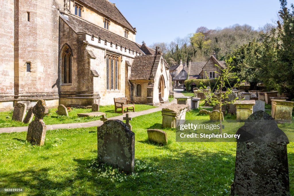 A quiet country churchyard in spring - St Andrews church in the south Cotswold village of Castle Combe, Wiltshire UK