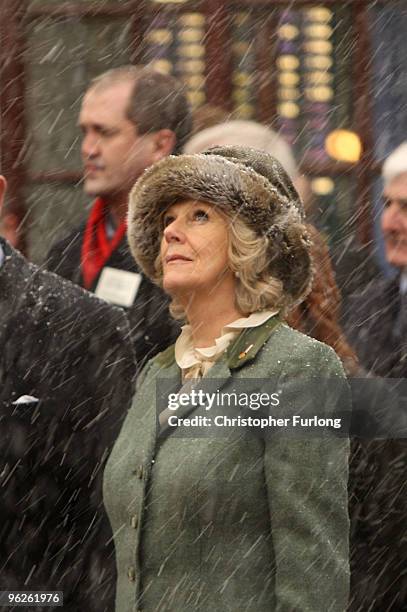 Camilla, Duchess of Cornwall looks to the sky as snow falls during a service in the High Street of Wootton Basset on January 29, 2010 in Wootton...