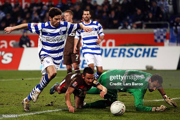 Deniz Naki of St. Pauli is challenged by Olivier Veigneau and goalkeeper Tom Starke of Duisburg during the Second Bundesliga match between MSV...