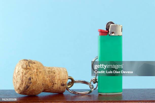 cava cork keyring holding green cigarette lighter - cork stopper bildbanksfoton och bilder
