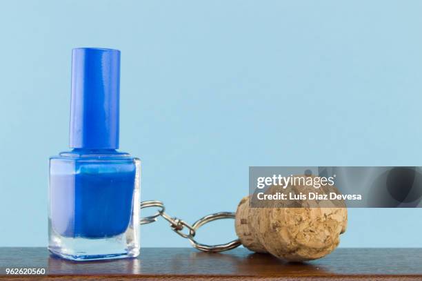 cava cork keyring holding blue nail polish - cork stopper bildbanksfoton och bilder