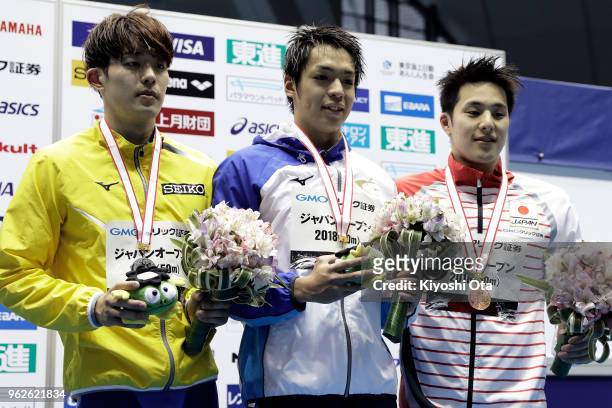 Winner Yuya Yajima of Japan celebrates with runner-up Masato Sakai of Japan and third-placed Daiya Seto of Japan after the Men's 200m Butterfly final...