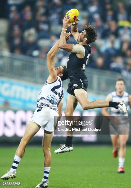 Dale Thomas of the Blues marks the ball against Aaron Black of the Cats during the round 10 AFL match between the Geelong Cats and the Carlton Blues...