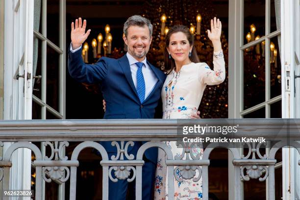 Crown Prince Frederik of Denmark and Crown Princess Mary of Denmark appear on the balcony as the Royal Life Guards carry out the changing of the...
