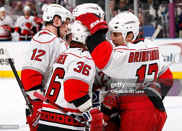 Rod Brind'Amour, Eric Staal, and Jussi Jokinen of the Carolina Hurricanes celebrate a goal against the New York Rangers on January 27, 2010 at...