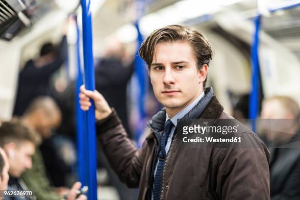 uk, london, portrait of businessman in underground train - london underground 個照片及圖片檔