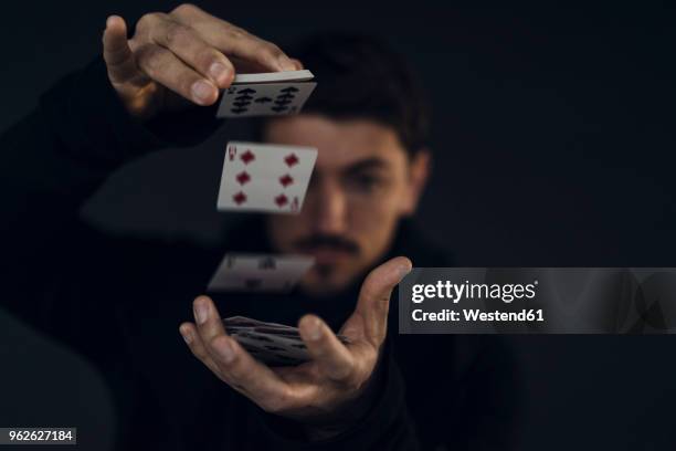 magician conjuring with playing cards, close-up - magician cards stock pictures, royalty-free photos & images