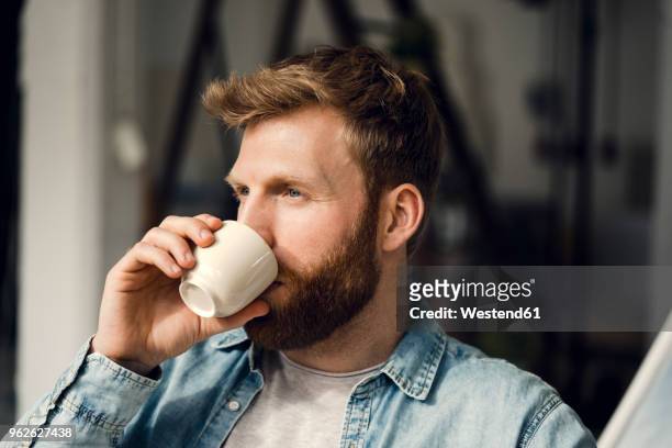 man relaxing at home, drinking coffee - coffee drink photos et images de collection