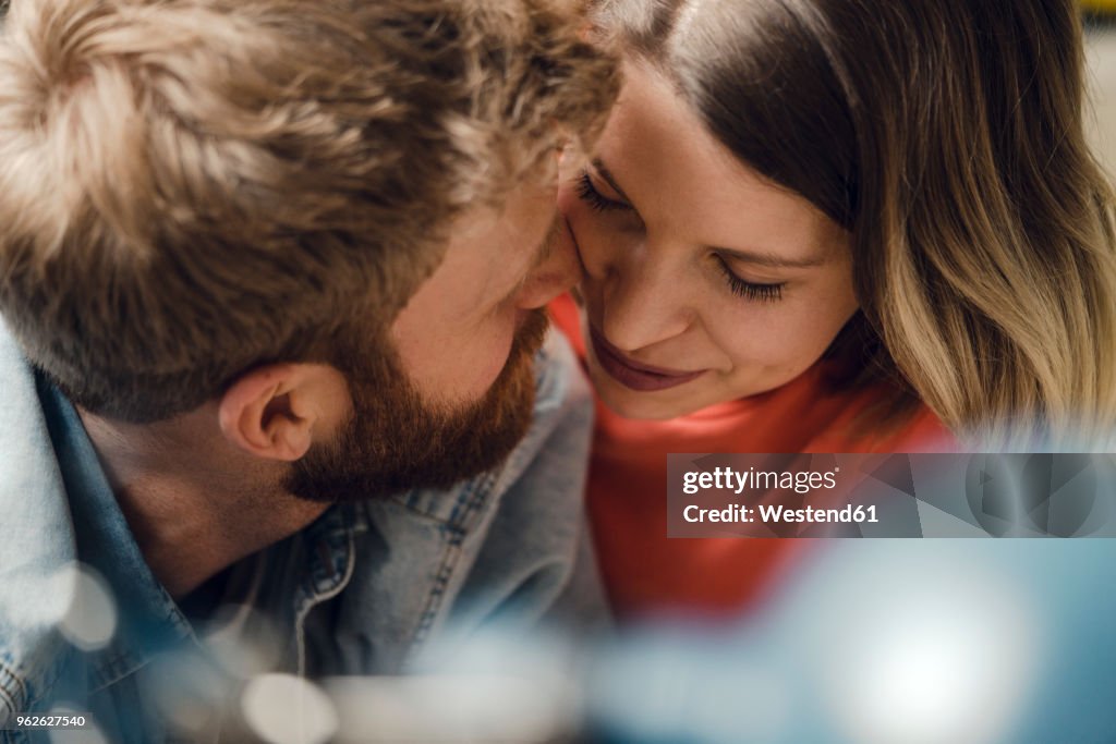 Affectionate couple cuddling at home