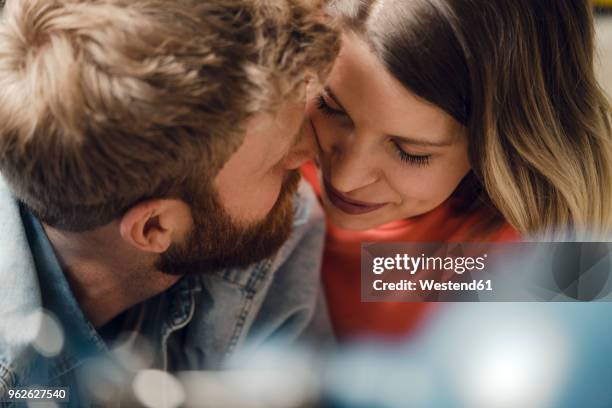 affectionate couple cuddling at home - liebe stock-fotos und bilder