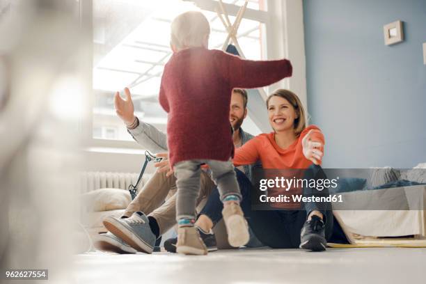 happy family playing with their son at home - mother running foto e immagini stock