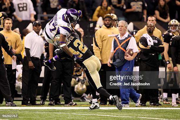 Darren Sharper of the New Orleans Saints hits Bernard Berrian of the Minnesota Vikings during the NFC Championship Game at the Louisiana Superdome on...