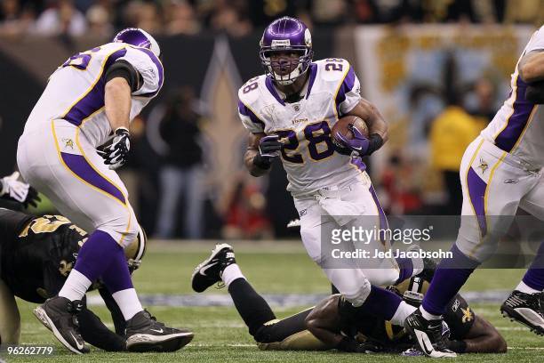 Adrian Peterson of the Minnesota Vikings runs with the ball against the New Orleans Saints during the NFC Championship Game at the Louisiana...