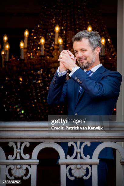 Crown Prince Frederik of Denmark reacts on the balcony as the Royal Life Guards carry out the changing of the guard on Amalienborg Palace square on...