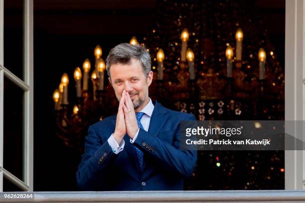 Crown Prince Frederik of Denmark reacts on the balcony as the Royal Life Guards carry out the changing of the guard on Amalienborg Palace square on...