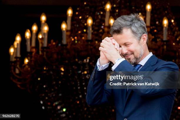 Crown Prince Frederik of Denmark reacts on the balcony as the Royal Life Guards carry out the changing of the guard on Amalienborg Palace square on...