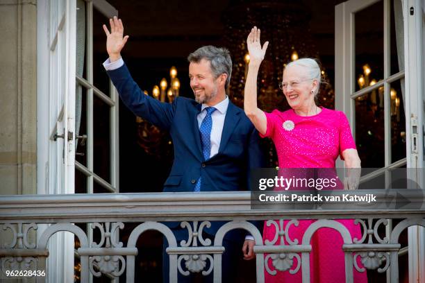 Queen Margrethe of Denmark and Crown Prince Frederik of Denmark wave as the Royal Life Guards carry out the changing of the guard on Amalienborg...