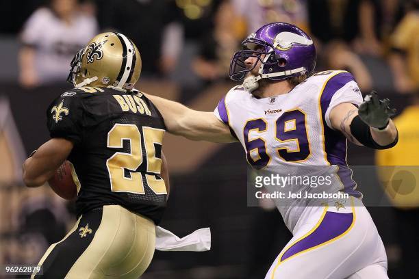 Reggie Bush of the New Orleans Saints attempts to break the grasp Jared Allen of the Minnesota Vikings on a double reverse play during the NFC...