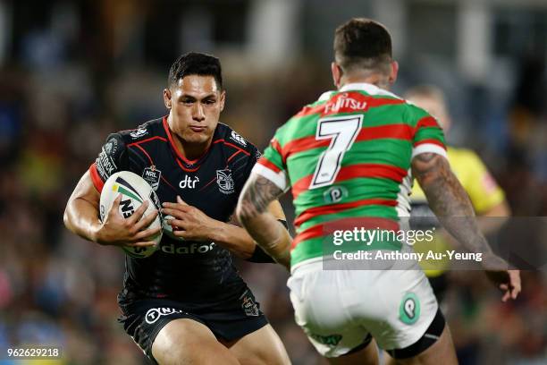 Roger Tuivasa-Sheck of the Warriors makes a run at Adam Reynolds of the Rabbitohs during the round 12 NRL match between the New Zealand Warriors and...