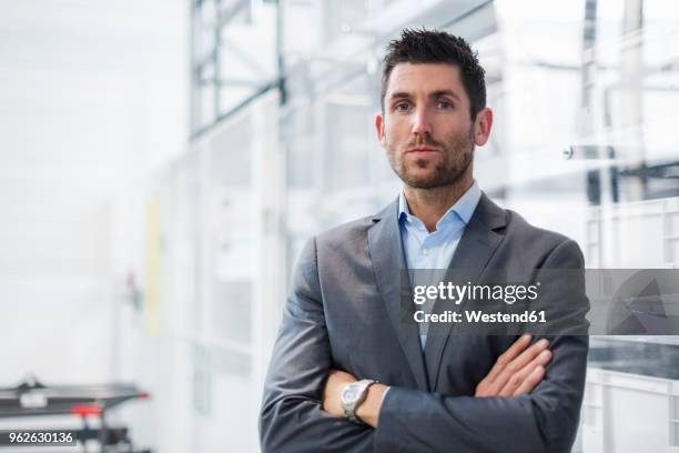 portrait of confident businessman in modern factory - metallic blazer stock pictures, royalty-free photos & images