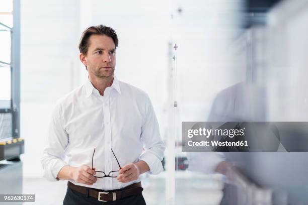 portrait of businessman in a factory - white shirt stock pictures, royalty-free photos & images