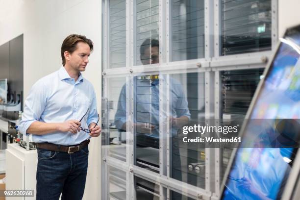 Machine Looking Left Businessman Looking At Machine In A Factory High-Res Stock Photo ...