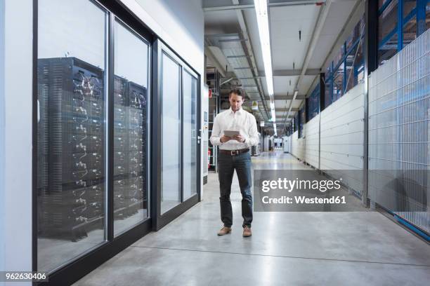 businessman using tablet in modern factory - easy access chef stockfoto's en -beelden