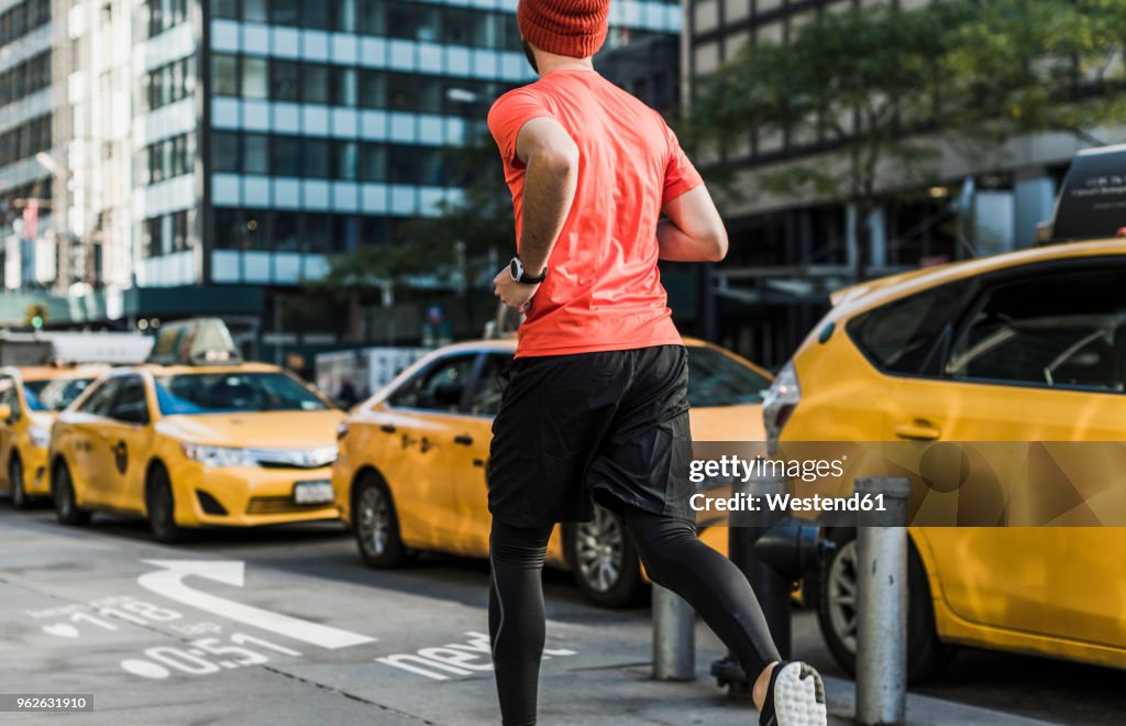 USA, New York City, man running in the city with data on pavement