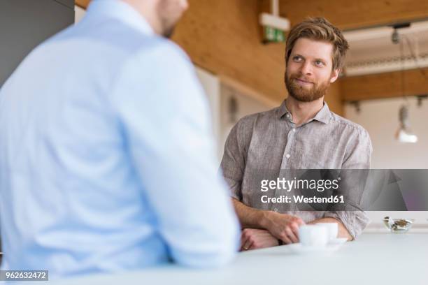 two businessmen talking in break room - coffee break office stock pictures, royalty-free photos & images