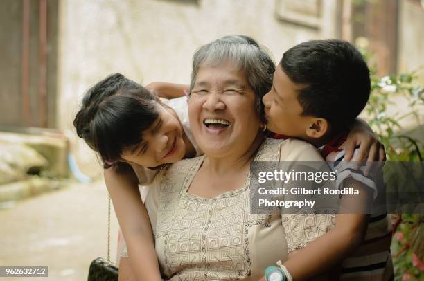 grandmother with grandchildren - filipino culture stock pictures, royalty-free photos & images