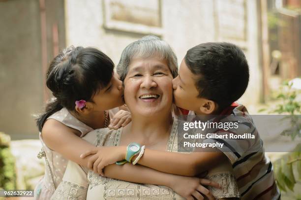 grandmother with grandchildren - philippines family stock pictures, royalty-free photos & images