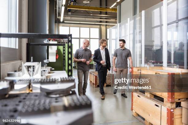 three men walking and talking in factory - switzerland business stock pictures, royalty-free photos & images